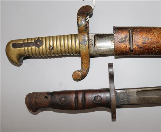 A French Yataghan bayonet and scabbard and a US WWI bayonet and scabbard dated 1917 by Remington